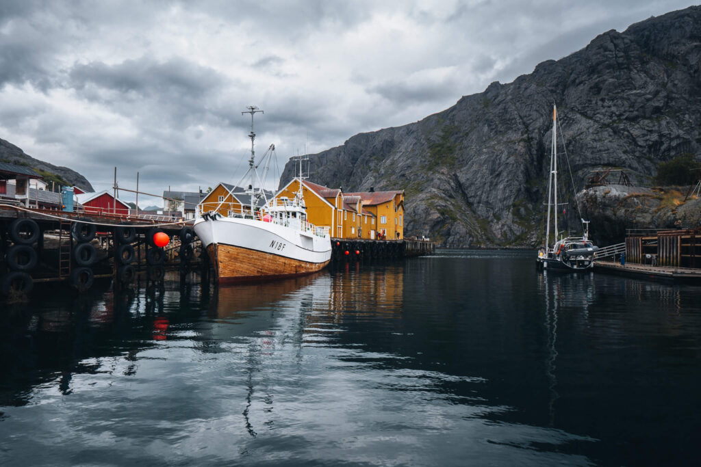 Fishing boats and traditional rorbuer houses in Nusfjord harbour on the Lofoten Islands in Norway
