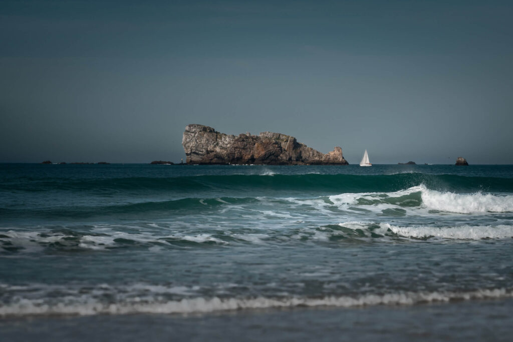 View from Plage de Pen-Hat towards the rocky coast of the Crozon Peninsula in Brittany, France